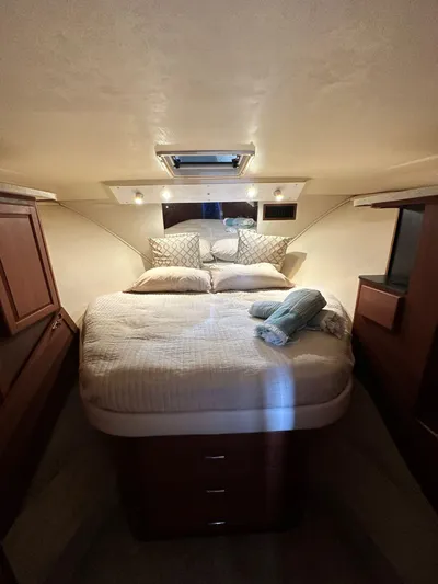  Yacht Photos Pics 2005 Luhrs 38 Convertible cabin with cozy bed and wooden cabinetry.