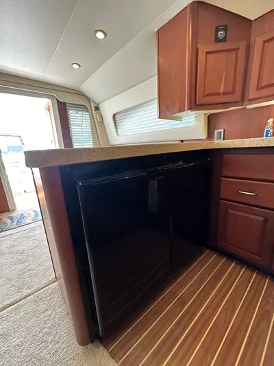  Yacht Photos Pics 2005 Luhrs 38 Convertible yacht interior with wood cabinetry and flooring.