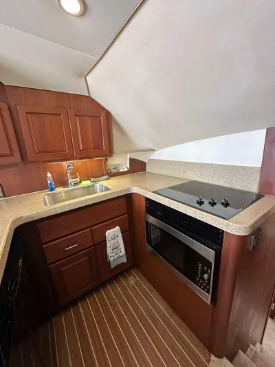  Yacht Photos Pics 2005 Luhrs 38 Convertible yacht kitchen with wood cabinetry and modern appliances.