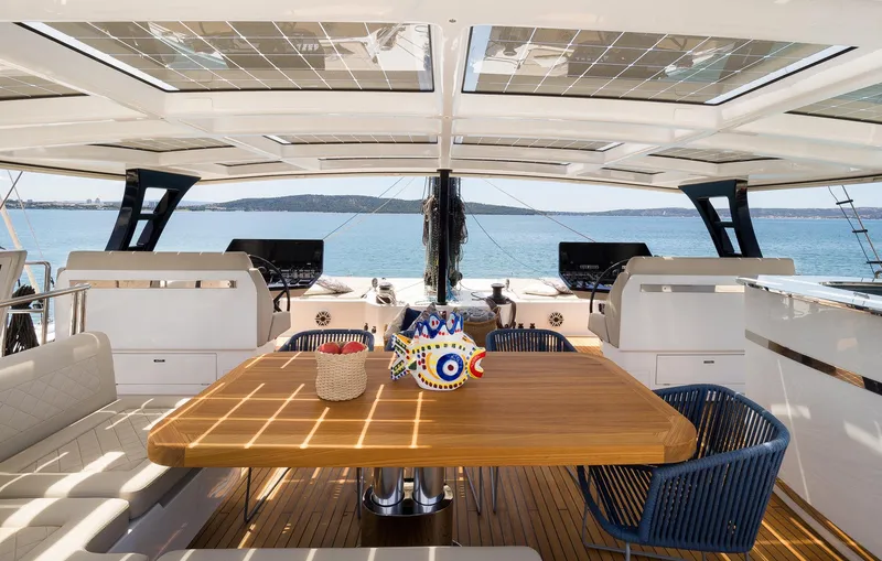 Dessus Yacht Photos Pics Luxurious Sunreef 60 yacht interior, featuring a spacious dining area with ocean views, 2022 model.