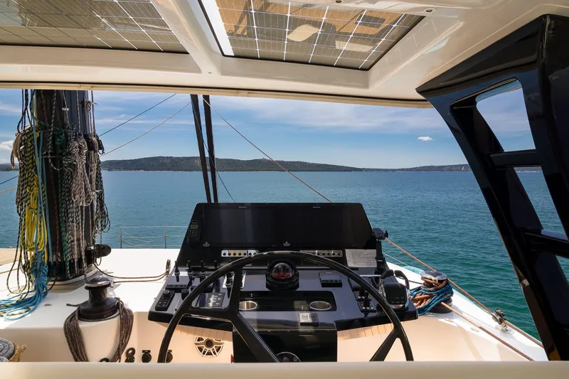Dessus Yacht Photos Pics Helm of 2022 Sunreef 60 yacht with ocean view and modern navigation equipment.