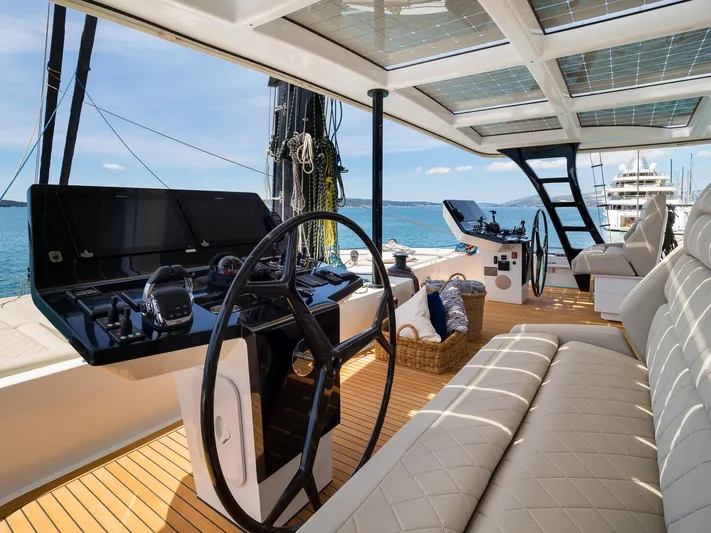 Dessus Yacht Photos Pics Luxurious Sunreef 60 yacht interior, 2022 model, featuring modern helm and seating area.