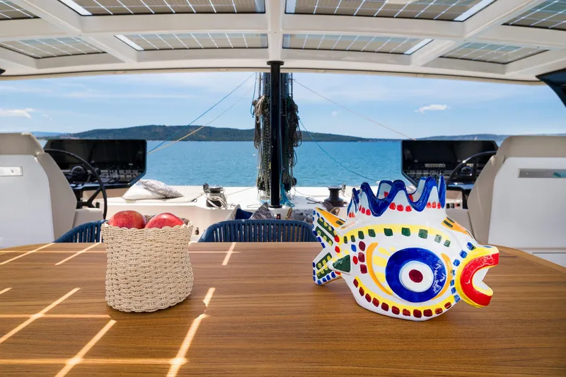 Dessus Yacht Photos Pics Luxurious Sunreef 60 yacht interior with decorative fish sculpture and fruit basket, 2022 model.