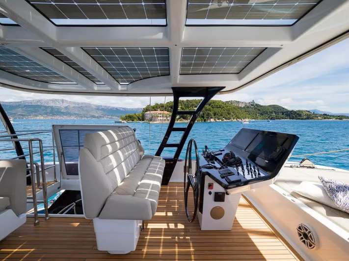 Dessus Yacht Photos Pics Sunreef 60 yacht interior with modern helm, solar panels, and scenic ocean view, 2022 model.
