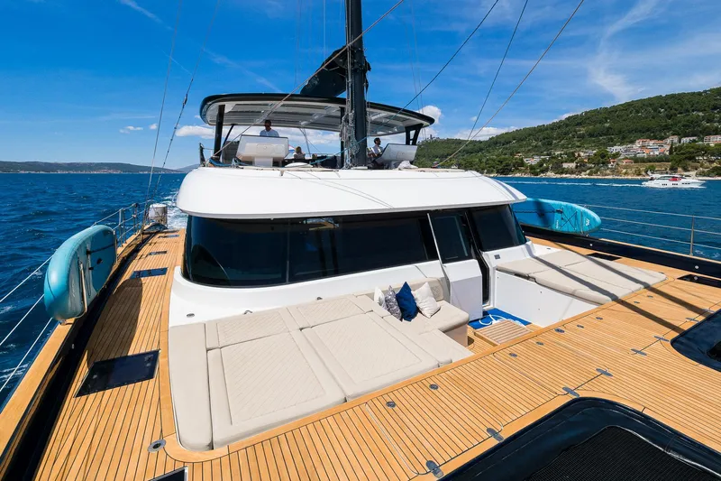 Dessus Yacht Photos Pics Luxurious 2022 Sunreef 60 yacht on open sea with spacious deck and modern design.