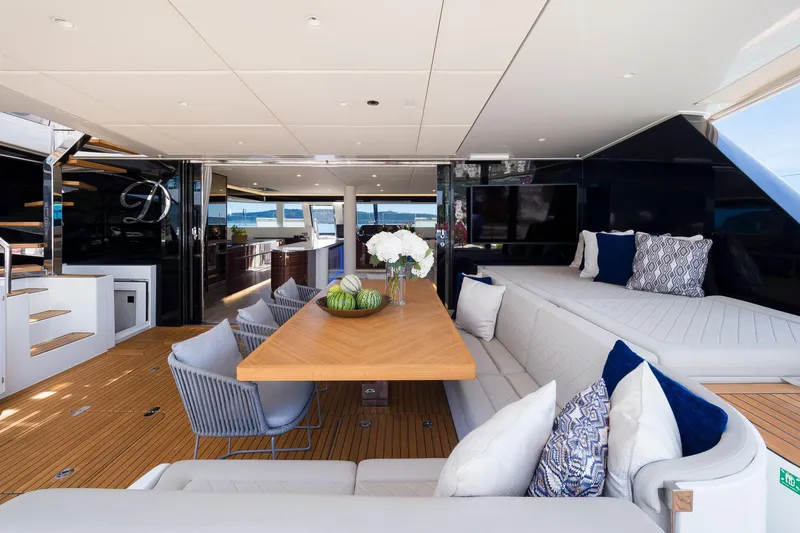 Dessus Yacht Photos Pics Luxurious Sunreef 60 yacht interior, 2022 model, featuring elegant seating and a stylish dining area.