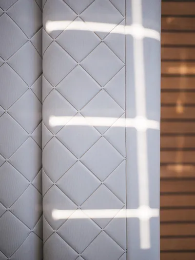 Dessus Yacht Photos Pics Quilted interior detail of 2022 Sunreef 60 yacht with sunlight pattern.