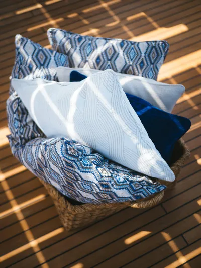 Dessus Yacht Photos Pics Decorative pillows in a basket on Sunreef 60 yacht's wooden deck, 2022 model.