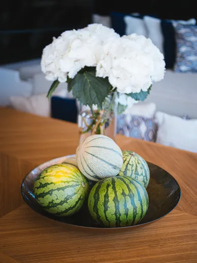 Dessus Yacht Photos Pics Bowl of watermelons and melons with white flowers on Sunreef 60 yacht, 2022.