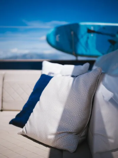 Dessus Yacht Photos Pics Luxurious Sunreef 60 yacht deck with cushions, 2022 model, featuring a serene ocean backdrop.