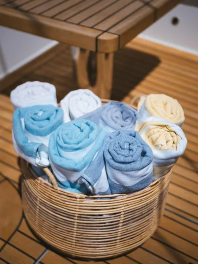 Dessus Yacht Photos Pics Rolled towels in a wicker basket on Sunreef 60 yacht deck, 2022 model.