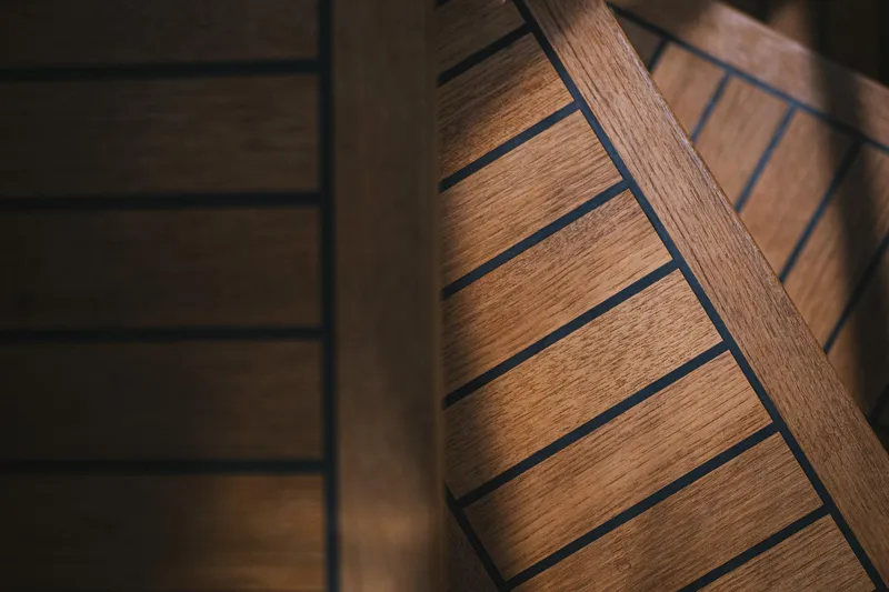 Dessus Yacht Photos Pics Wooden deck detail on 2022 Sunreef 60 yacht, showcasing elegant craftsmanship and design.