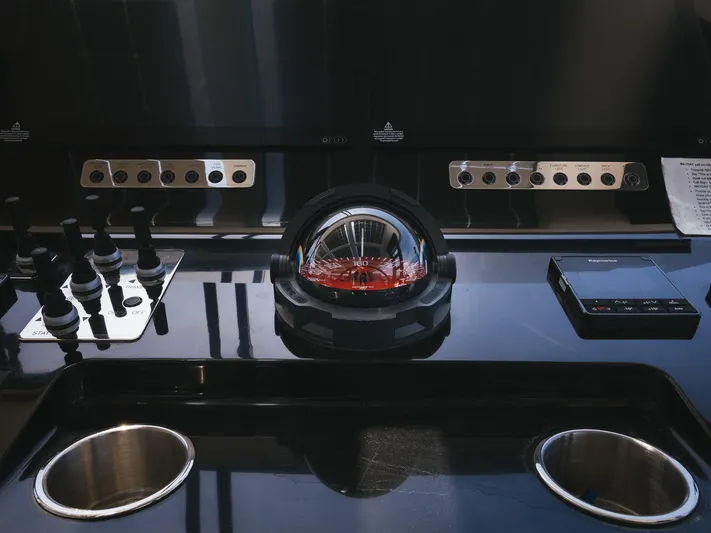 Dessus Yacht Photos Pics Control panel of a 2022 Sunreef 60 yacht with navigation instruments and controls.