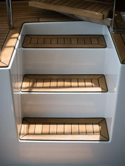 Dessus Yacht Photos Pics Staircase on 2022 Sunreef 60 yacht with wooden steps and sleek design.