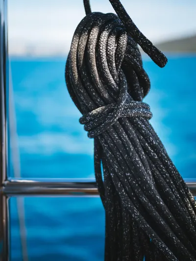 Dessus Yacht Photos Pics Coiled rope on Sunreef 60 yacht, 2022, against a blue ocean backdrop.