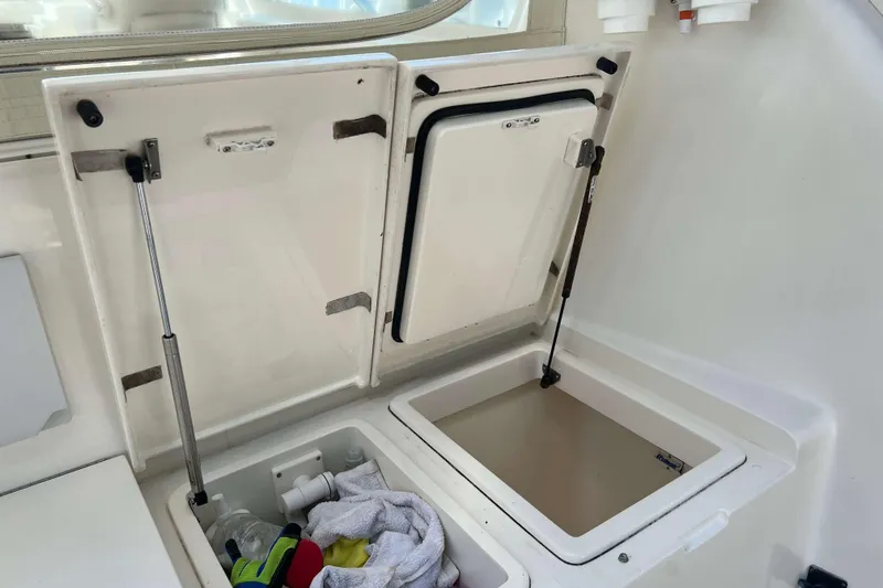  Yacht Photos Pics Open storage compartments on a 2007 Henriques 42 Express boat, showing interior space.
