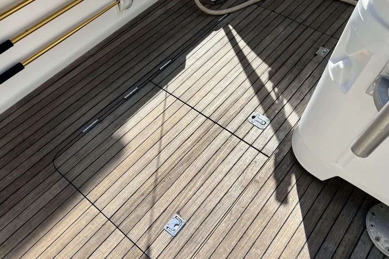  Yacht Photos Pics Teak deck of 2007 Henriques 42 Express boat with metal fittings and shadows.
