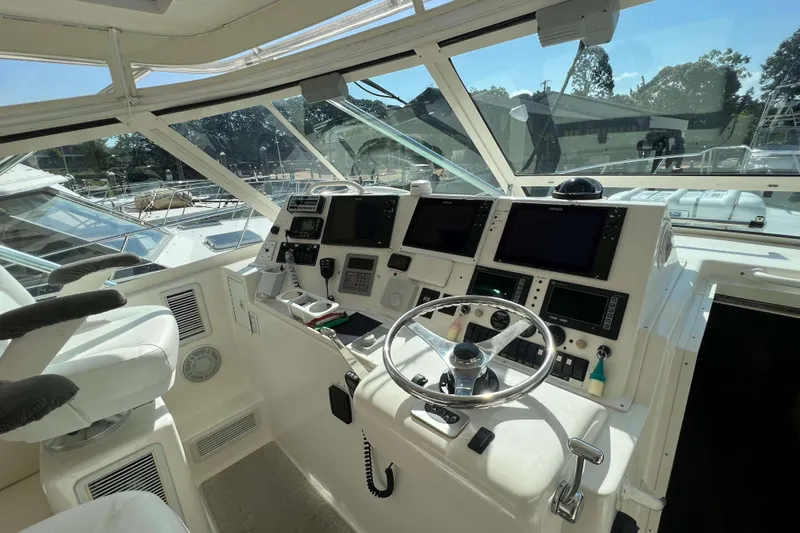  Yacht Photos Pics Helm of 2007 Henriques 42 Express boat with advanced navigation equipment and controls.