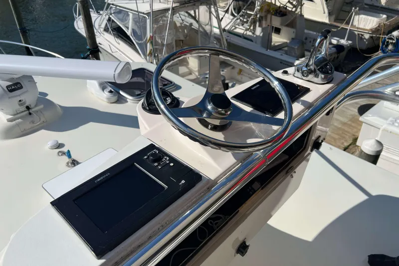  Yacht Photos Pics 2007 Henriques 42 Express helm with steering wheel and navigation controls.