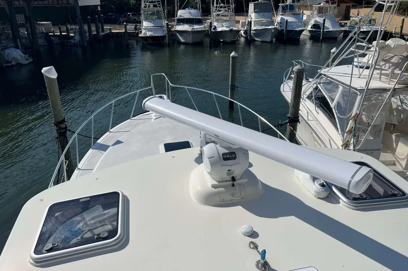  Yacht Photos Pics 2007 Henriques 42 Express yacht docked at marina, featuring radar equipment on deck.