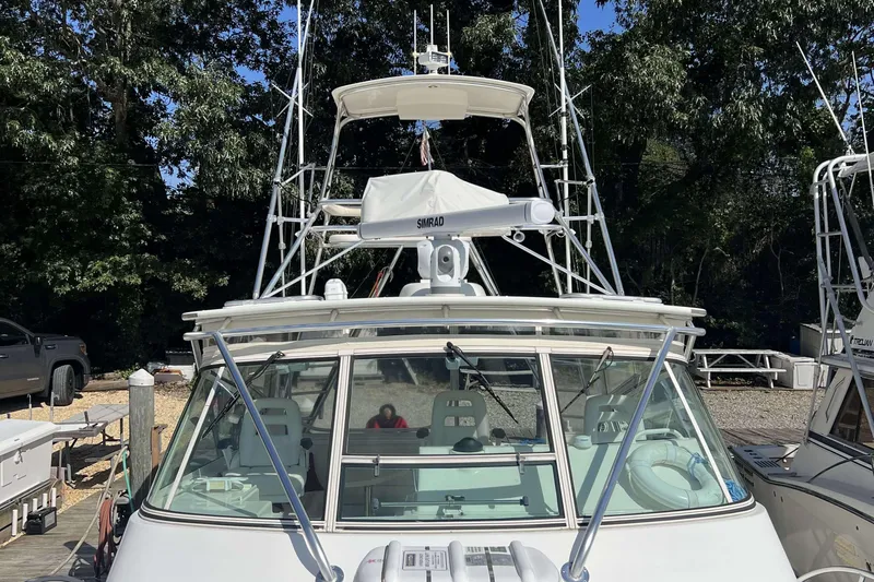  Yacht Photos Pics 2007 Henriques 42 Express boat docked, featuring radar equipment and fishing tower.