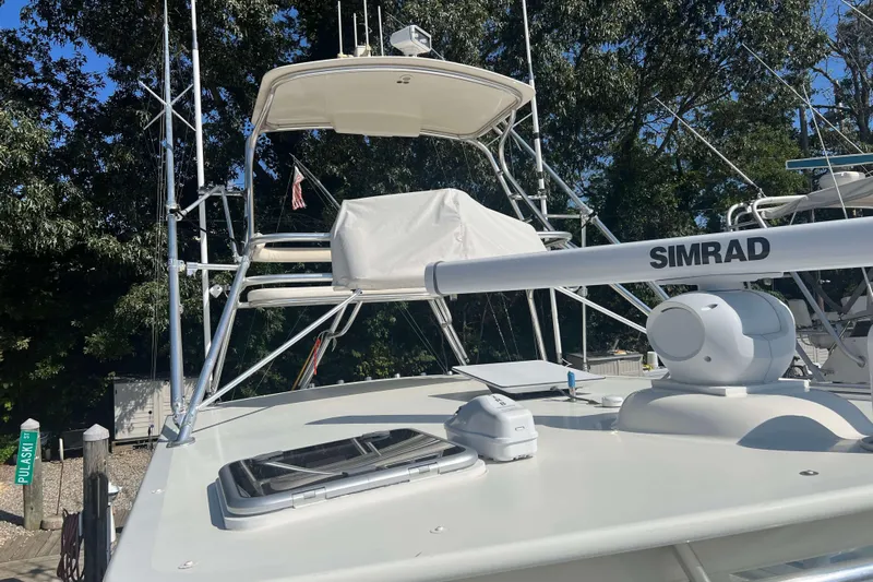  Yacht Photos Pics 2007 Henriques 42 Express boat with Simrad radar, docked near trees.