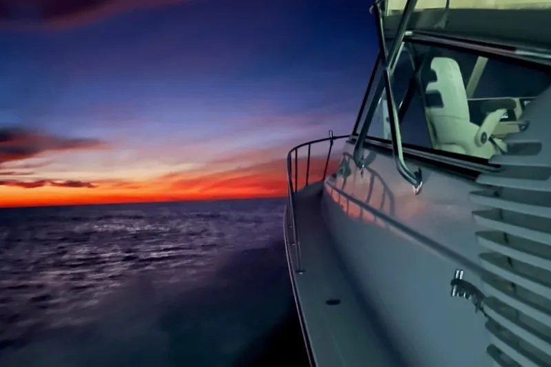  Yacht Photos Pics Henriques 42 Express 2007 yacht cruising at sunset on the ocean.