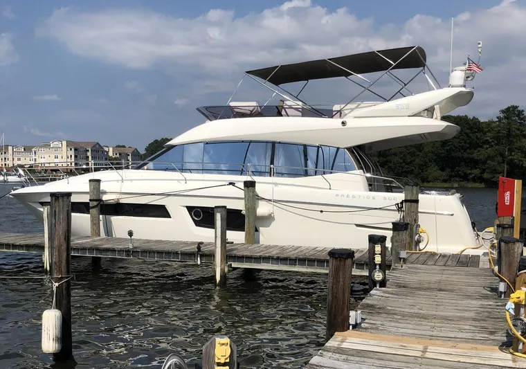 Relax Yacht Photos Pics Luxury 2015 Prestige 500 yacht docked at a marina under a clear sky.