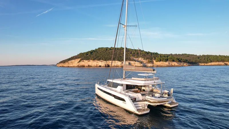 Solaia Yacht Photos Pics Luxury Leopard 50 catamaran sailing near scenic island, 2020 model.