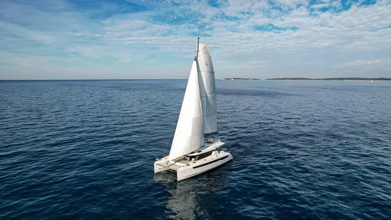 Solaia Yacht Photos Pics Sailing catamaran Leopard 50 on open sea under blue sky, 2020 model.