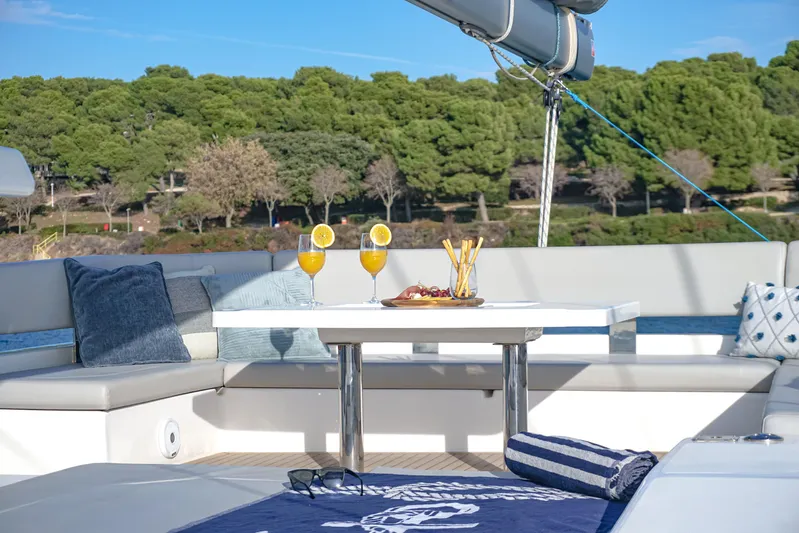 Solaia Yacht Photos Pics Luxurious Leopard 50 yacht deck with drinks, snacks, and scenic forest view.