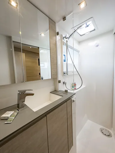 Solaia Yacht Photos Pics Modern yacht bathroom with sleek fixtures, mirror cabinets, and overhead lighting in a Leopard 50 model.