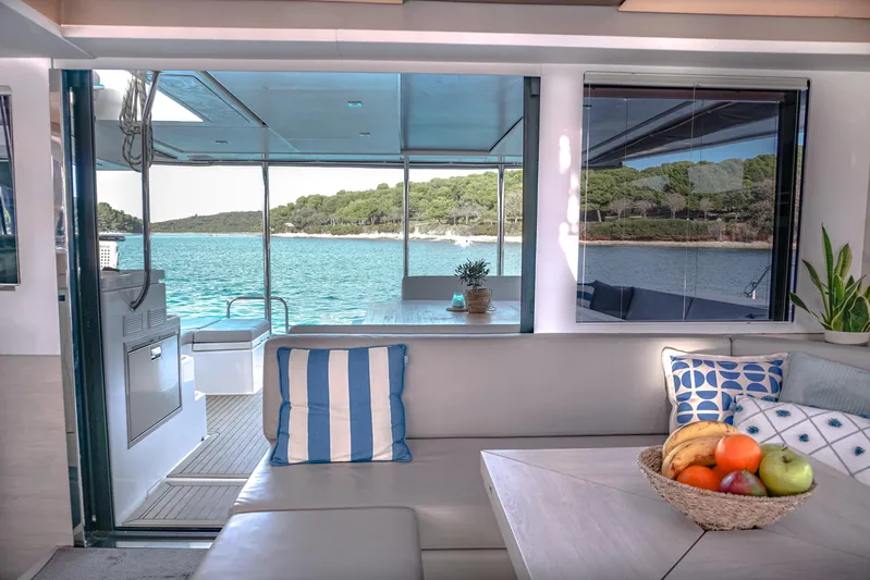 Solaia Yacht Photos Pics Luxurious Leopard 50 yacht interior with fruit basket, cushions, and scenic ocean view.