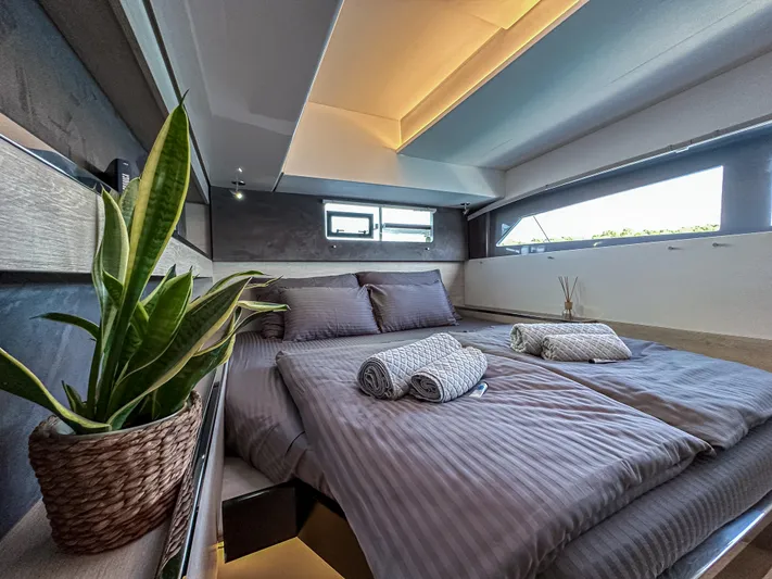 Solaia Yacht Photos Pics Luxurious bedroom interior on a 2020 Leopard 50 yacht with modern decor and natural light.