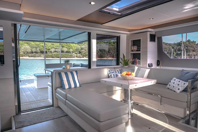 Solaia Yacht Photos Pics Luxurious interior of 2020 Leopard 50 yacht with modern seating and scenic water view.