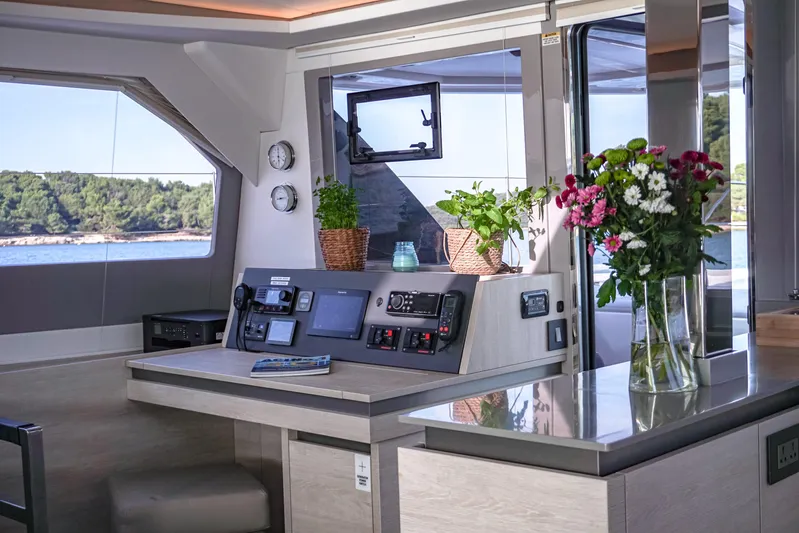 Solaia Yacht Photos Pics Luxurious interior of 2020 Leopard 50 yacht with modern navigation panel and floral decor.