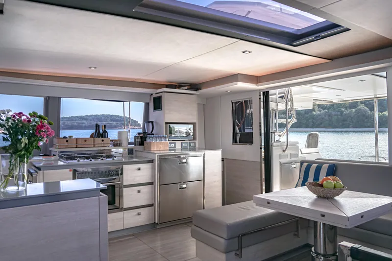 Solaia Yacht Photos Pics Luxurious Leopard 50 yacht interior with modern kitchen and dining area, overlooking serene waters.