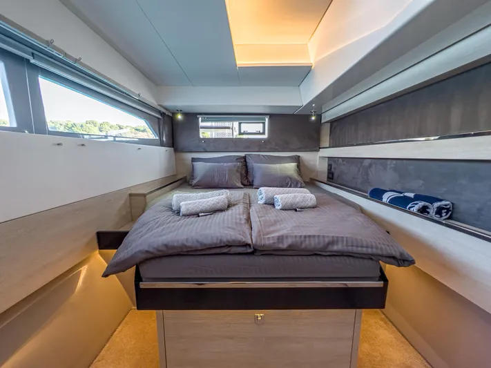 Solaia Yacht Photos Pics Luxurious bedroom interior on a 2020 Leopard 50 yacht, featuring modern design and cozy bedding.