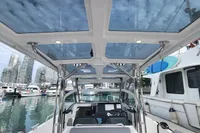 2023 Nimbus T9 X-Edition boat with glass roof, docked in a modern marina.