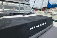 2023 Nimbus T9 X-Edition boat with sleek design, docked near other vessels.