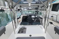 2023 Nimbus T9 X-Edition boat interior with steering wheel and sink, docked at marina.
