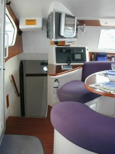Ocean Mandalay Yacht Photos Pics Interior of a 2003 Fountaine Pajot Belize 43 yacht with purple seating.