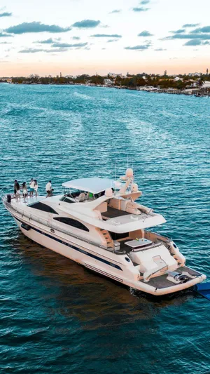  Yacht Photos Pics Luxurious 1998 Astondoa 72 GLX yacht cruising on serene waters at sunset.
