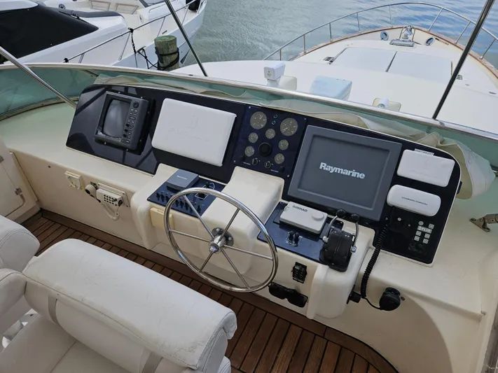  Yacht Photos Pics Astondoa 72 GLX 1998 yacht helm with Raymarine navigation system and wooden deck.