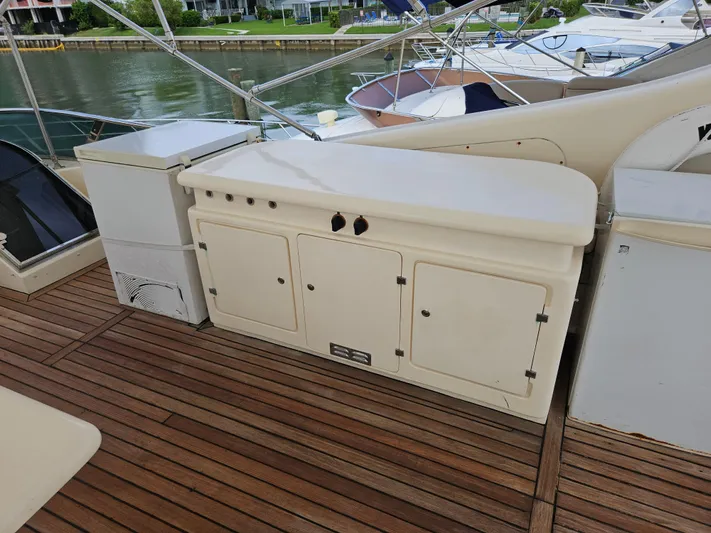  Yacht Photos Pics Astondoa 72 GLX 1998 yacht deck with wooden flooring and storage cabinets.