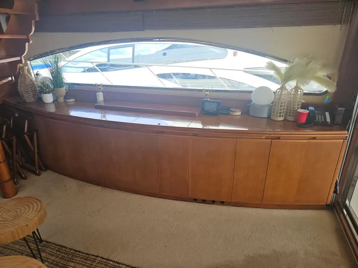  Yacht Photos Pics Interior of 1998 Astondoa 72 GLX yacht with wooden cabinetry and decorative items.