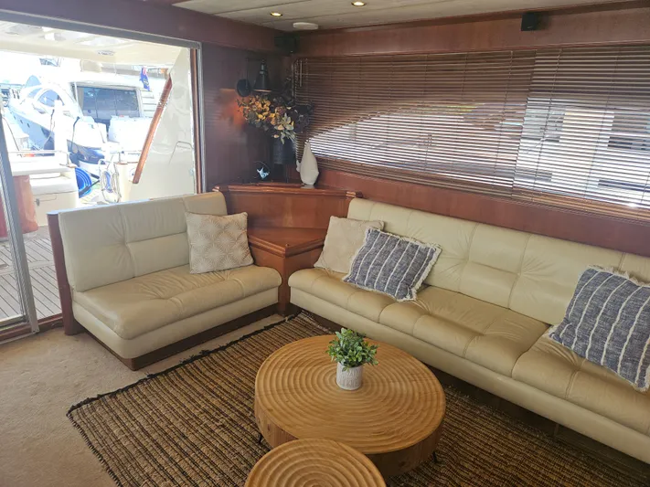  Yacht Photos Pics Luxurious interior of 1998 Astondoa 72 GLX yacht with beige leather seating and wooden accents.