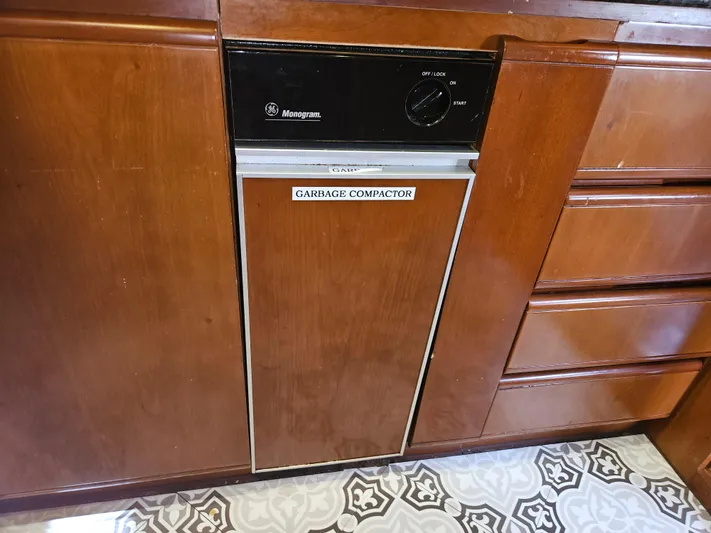  Yacht Photos Pics Wooden kitchen cabinetry with a built-in Monogram garbage compactor on Astondoa 72 GLX yacht.