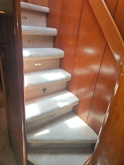  Yacht Photos Pics Interior staircase of 1998 Astondoa 72 GLX yacht with wooden paneling.
