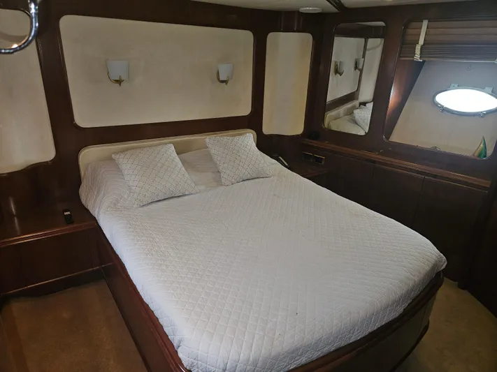  Yacht Photos Pics Luxurious bedroom interior of 1998 Astondoa 72 GLX yacht with elegant wood finishes.